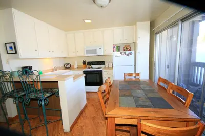 a kitchen and dining room with a table and chairs at Sierra Park Villas 16 in Mammoth Lakes