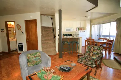 a living room with a table and chairs and a kitchen at Sierra Park Villas 16 in Mammoth Lakes