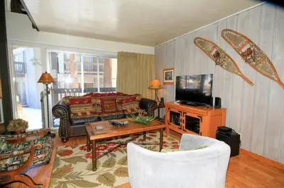 a living room with a couch and a tv at Sierra Park Villas 16 in Mammoth Lakes