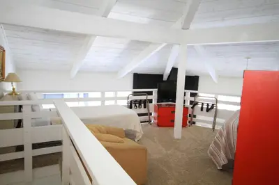 a bedroom with two beds and a couch in it at Sierra Park Villas 89 in Mammoth Lakes