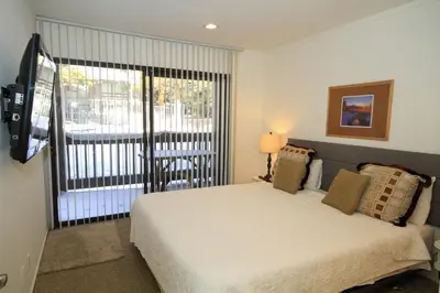 a bedroom with a bed and a large window at Sierra Park Villas 89 in Mammoth Lakes