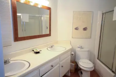 a bathroom with a sink and a toilet and a mirror at Sierra Park Villas 89 in Mammoth Lakes