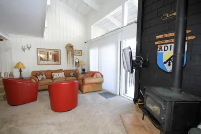 a living room with a fireplace and a couch at Sierra Park Villas 89 in Mammoth Lakes