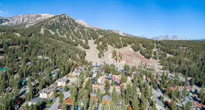 an aerial view of a mountain with trees and buildings at 623 home in Mammoth Lakes