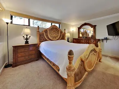 a bedroom with a large bed and a mirror at 623 home in Mammoth Lakes