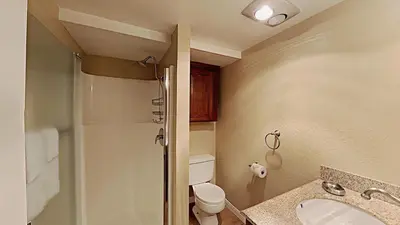 a bathroom with a toilet and a sink and a shower at Comfy 2-Bedroom Home with Pool in Mammoth Lakes
