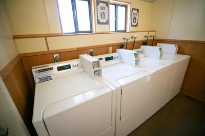 a row of washers and dryers in a utility room at Comfy 2-Bedroom Home with Pool in Mammoth Lakes