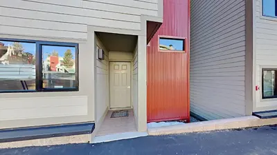 a building with a red door and a window at Remodeled 2 Bedroom Condo with Amazing Views! in Mammoth Lakes