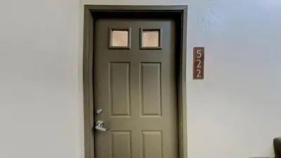a green door in a room next to a wall at Remodeled 2 Bedroom Condo with Amazing Views! in Mammoth Lakes