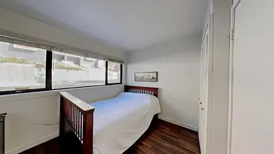 a small bedroom with a bed and a window at Spacious 2 Bedroom Home with Pool in Mammoth Lakes
