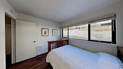 a bedroom with a bed and a large window at Spacious 2 Bedroom Home with Pool in Mammoth Lakes
