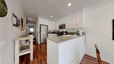 a kitchen with white cabinets and a white counter top at Spacious 2 Bedroom Home with Pool in Mammoth Lakes