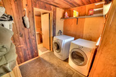 a small bathroom with a washing machine and a washer at sequoia National Forest CabinH in Panorama Heights
