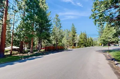an empty road with trees on either side at North Lake Loft in Kings Beach