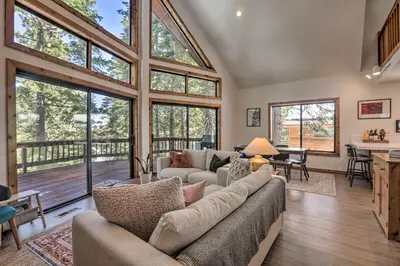 a living room with a couch and some windows at Tahoe Donner Retreat with Decks and Lake Access! in Truckee