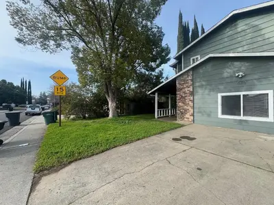 a street sign in front of a house at WHOLE Family - Rosemont in Sacramento
