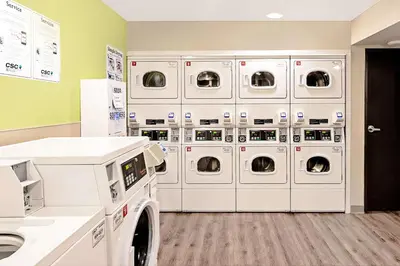 a laundry room with white washers and dryers at WoodSpring Suites Reno Sparks in Sparks
