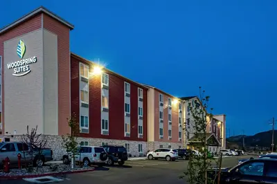 a hotel building with cars parked in a parking lot at WoodSpring Suites Reno Sparks in Sparks
