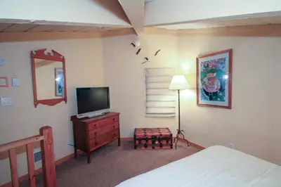 a bedroom with a bed and a television on a dresser at Sierra Park Villas 20 in Mammoth Lakes