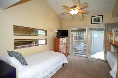 a bedroom with a bed and a ceiling fan at Sierra Park Villas 20 in Mammoth Lakes