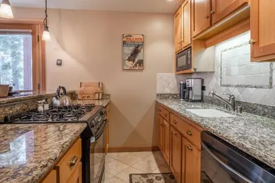 a kitchen with a stove and a sink at Northstar - Ski View Condo in Truckee