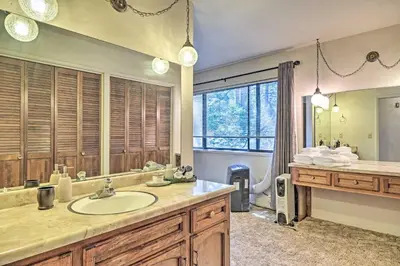 a bathroom with a sink and a large mirror at Home with Serene Deck in Twain Harte! in Twain Harte