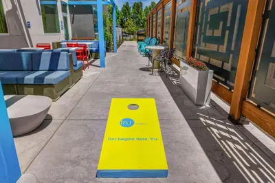a yellow and blue sign on the side of a sidewalk at Tru By Hilton Lathrop in Lathrop