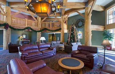 a living room with leather furniture and a wooden ceiling at Sunstone Lodge by 101 Great Escapes in Mammoth Lakes