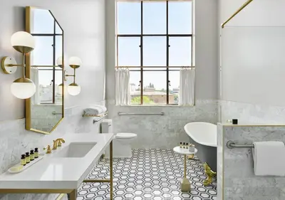 a white bathroom with a sink and a toilet at The Darling in Visalia