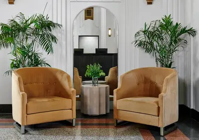 a waiting room with two chairs and a table at The Darling in Visalia