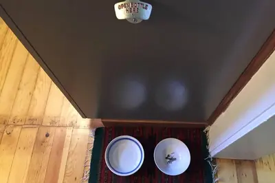 a room with a ceiling with two plates on a rug at Vans Yosemite Garden Cottage in Groveland