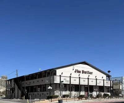 a large white building with a sign on it at Jim Butler Inn & Suites in Tonopah