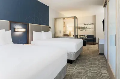a hotel room with two beds and a mirror at SpringHill Suites by Marriott Truckee Lake Tahoe in Truckee
