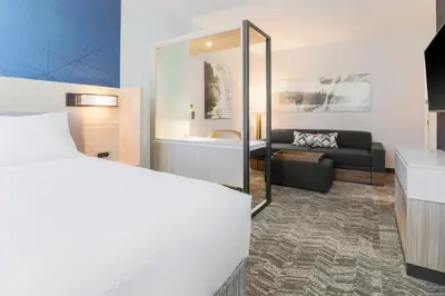 a bedroom with a bed and a living room at SpringHill Suites by Marriott Truckee Lake Tahoe in Truckee