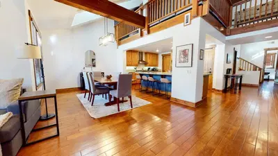 an open living room and dining room with a table and chairs at Snowcreek The Lodges #1130 condo in Mammoth Lakes