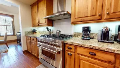 a kitchen with wooden cabinets and a stove top oven at Snowcreek The Lodges #1130 condo in Mammoth Lakes