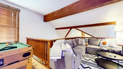 a living room with a couch and a pool table at Snowcreek The Lodges #1130 condo in Mammoth Lakes
