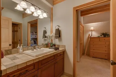 a bathroom with a sink and a mirror at Northstar Conifer Luxury Home home in Truckee