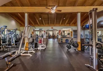 a gym with several treadmills and machines at Northstar Conifer Luxury Home home in Truckee