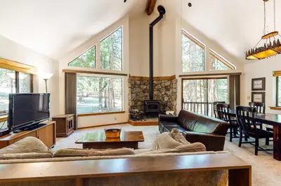 a living room with a couch and a tv at The Arrow House in Camp Connell