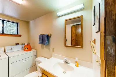 a bathroom with a sink and a toilet and a mirror at The Arrow House in Camp Connell