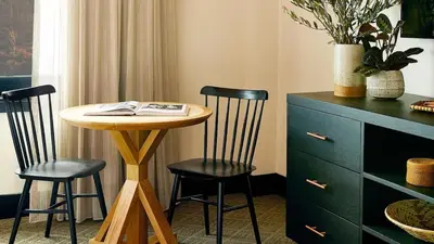 a small table with two chairs and a book on it at El Capitan Hotel in Merced
