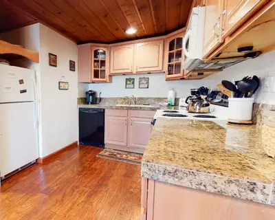 a kitchen with wooden floors and a white refrigerator at Val D'Isere #17 condo in Mammoth Lakes