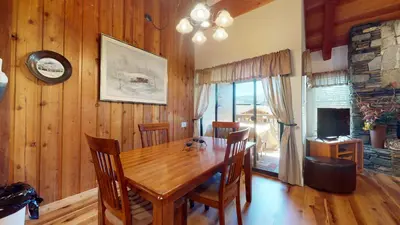 a dining room with a wooden table and chairs at Val D'Isere #17 condo in Mammoth Lakes