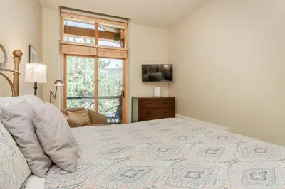 a bedroom with a large bed and a window at Solstice 24 in Mammoth Lakes