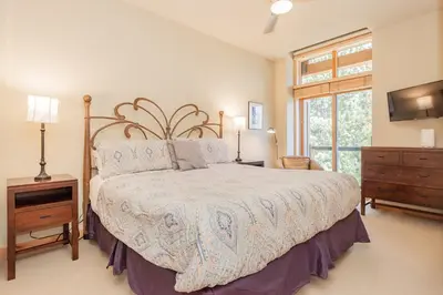 a bedroom with a large bed and a window at Solstice 24 in Mammoth Lakes