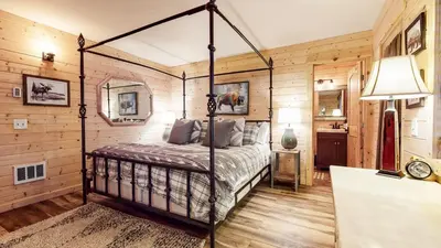a bedroom with a bed in a room with wooden walls at Forest Creek #29 condo in Mammoth Lakes