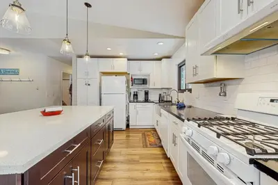 a kitchen with white cabinets and a stove top oven at Piney Retreat in Carnelian Bay