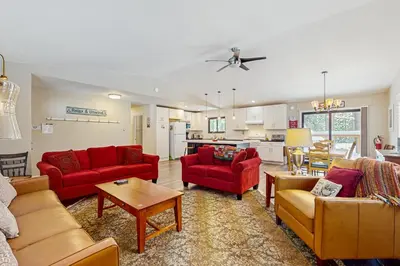 a living room with red furniture and a kitchen at Piney Retreat in Carnelian Bay