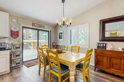 a kitchen and dining room with a table and chairs at Piney Retreat in Carnelian Bay